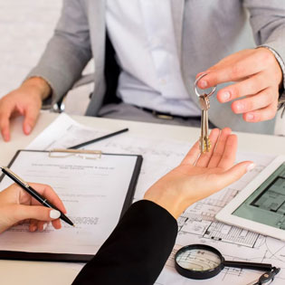 real estate agent handing over the keys to a tenant